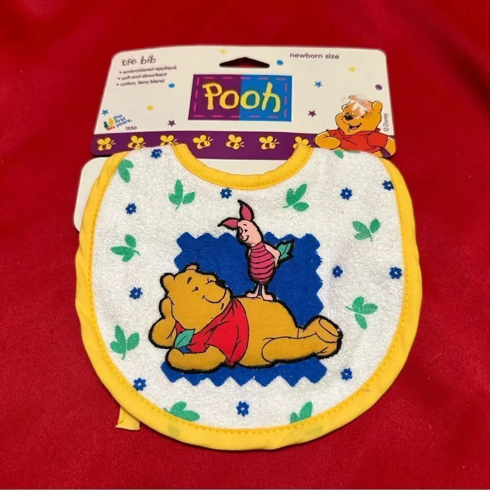 The first years Pooh Tie Bib Newborn